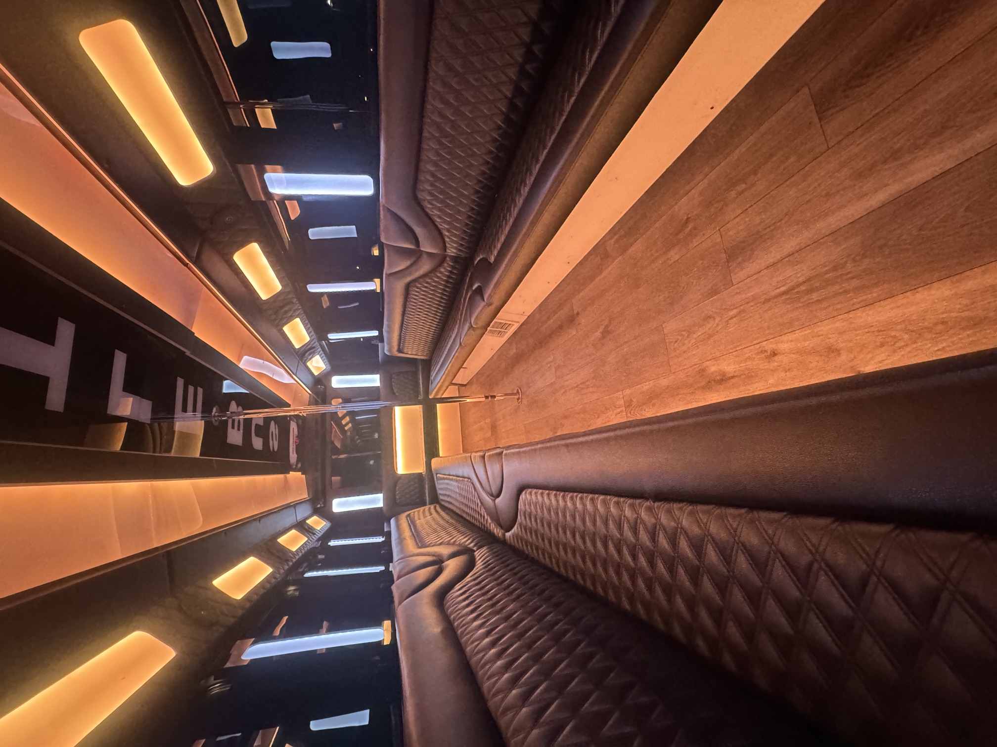 Luxury party bus interior with leather seating and ambient lighting